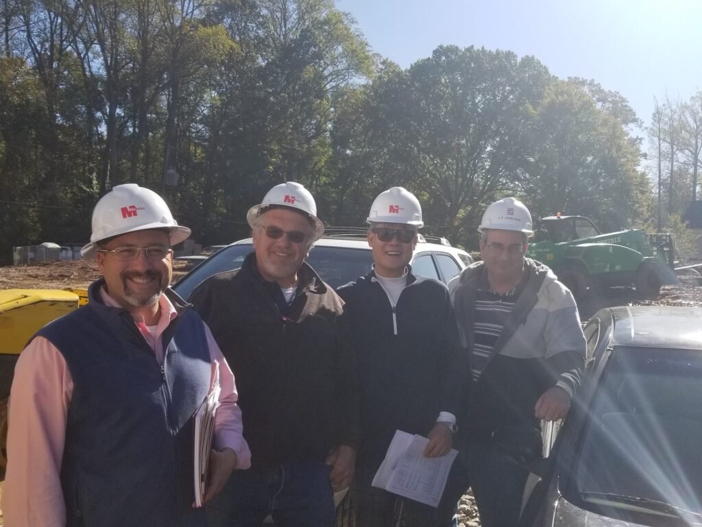 Steven at a commercial construction site with project team members