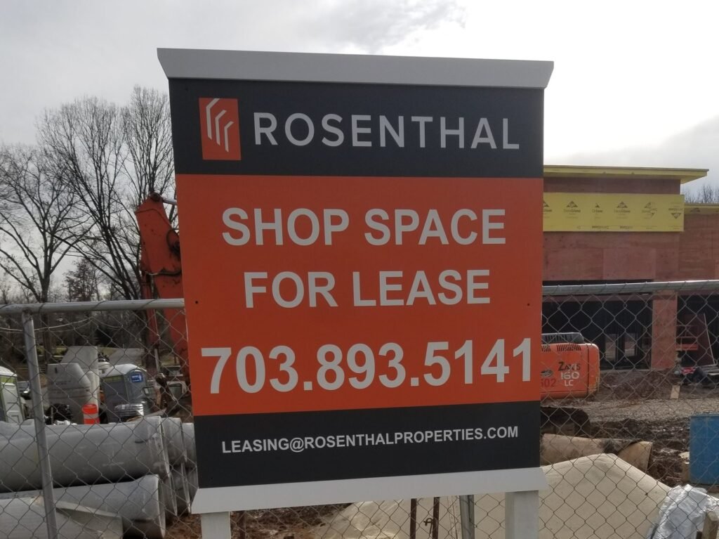 Shopping Center during development with a shop space for lease sign